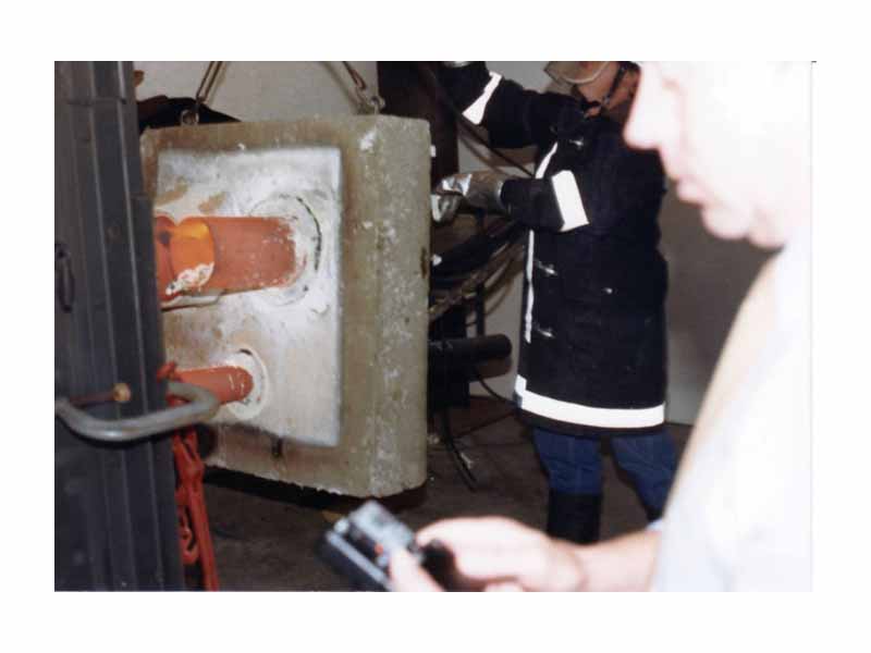 Fire test where the steel pipe penetrants clearly act to absorb and conduct heat from the furnace, through to the unexposed side.