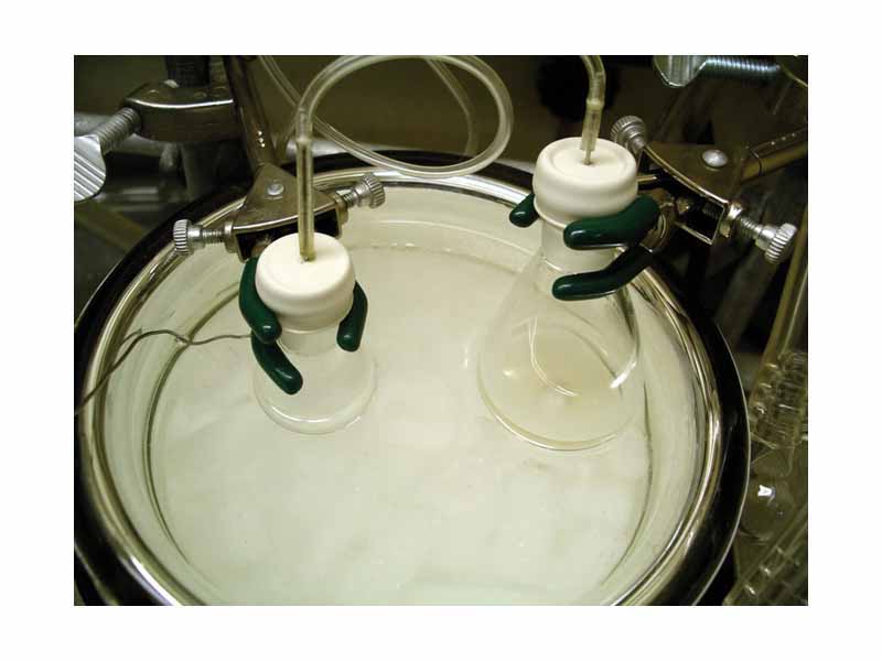 A typical experimental setup for an aldol reaction.  A solution of lithium diisopropylamide (LDA) in tetrahydrofuran (THF) (in the flask on the right) is being added to a solution of tert-butyl propionate in the flask on the left, forming its lithium enolate. An aldehyde can then be added to initiate an aldol addition reaction.  Both flasks are submerged in a dry ice/acetone cooling bath (-78 °C) the temperature of which is being monitored by a thermocouple (the wire on the left).